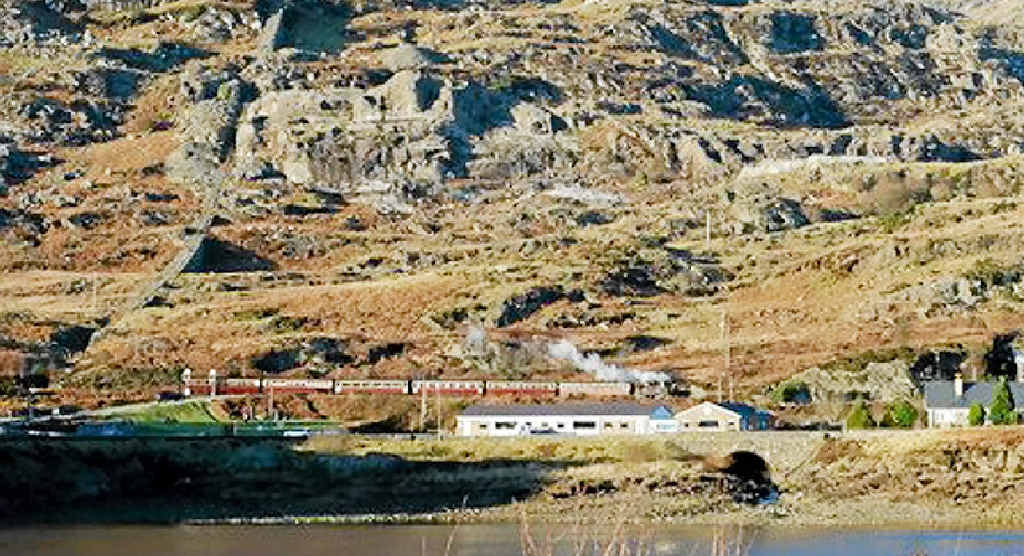 Dwarfed by the mountains, a Little Train appears even smaller. Dwarfed by the mountains, a Little Train appears even smaller.